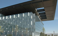 View of the glass façade of the main building of the Telefónica Telecommunications City, Madrid, Spain.