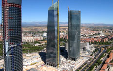 Aerial view of the Torre de Cristal building, showing three of the four towers in the centre of Madrid